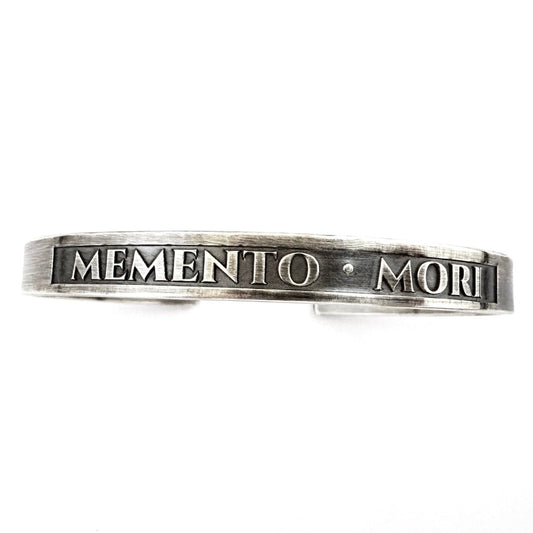Detail of the raised lettering and blackened panel on the sterling silver cuff