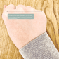 A woman's hand showing the correct measurement to take to determine bangle size.