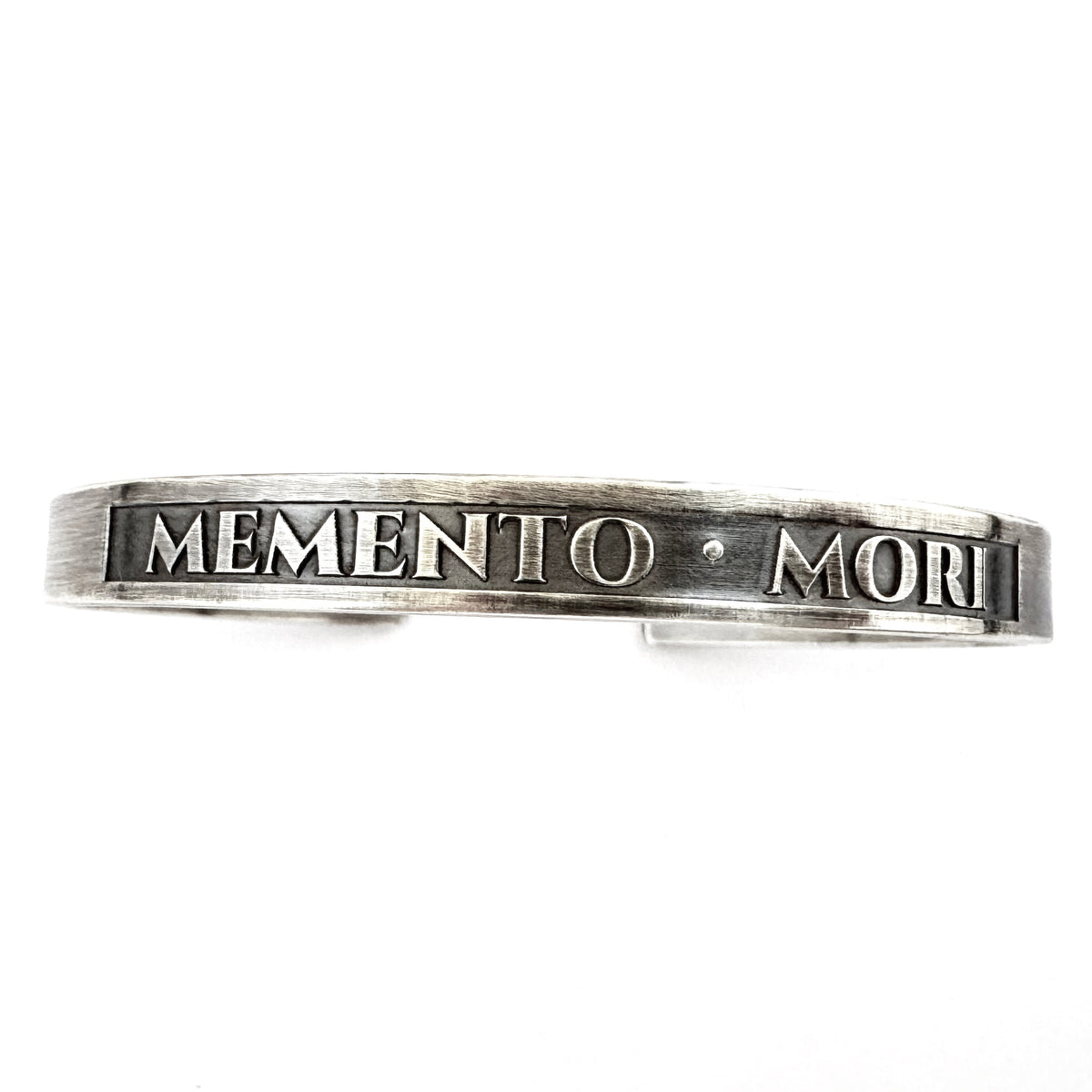 Detail of the raised lettering and blackened panel on the sterling silver cuff