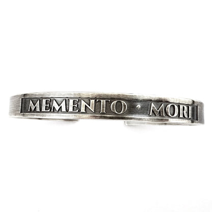 Detail of the raised lettering and blackened panel on the sterling silver cuff
