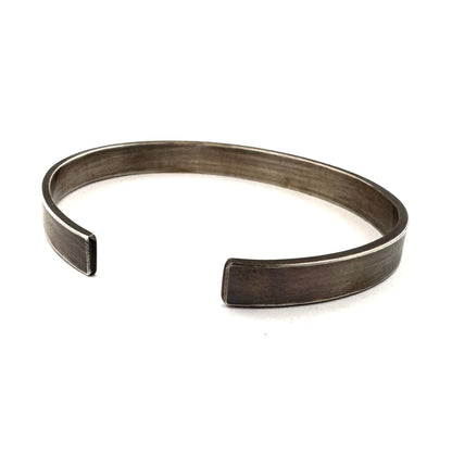Side profile of the memento mori cuff showing 2mm thickness and oxidised finish