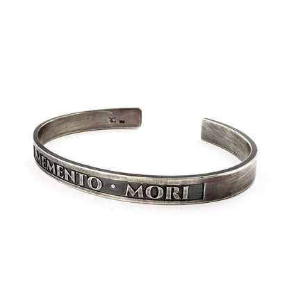 Oxidised silver memento mori cuff bracelet, side view showing the darkened finish