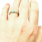 Set of 3 dainty gold rings with a turquoise cabochon on the ring finger of a white left hand
