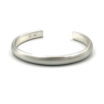Heavy half-round sterling silver cuff bracelet on a white background.