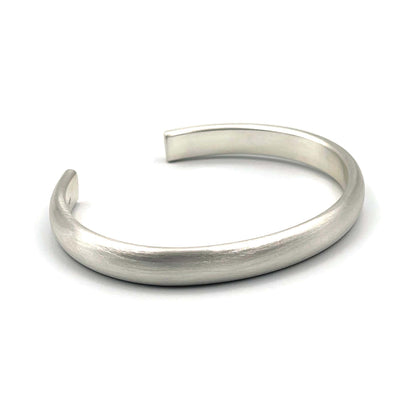Heavy half-round sterling silver cuff bracelet with a brush finish on a white background.