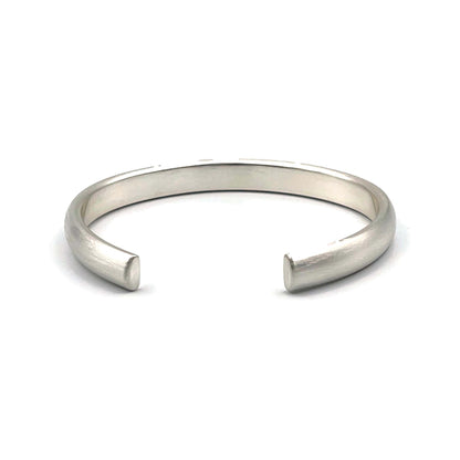 Heavy half-round sterling silver cuff bracelet with a brush finish on a white background.