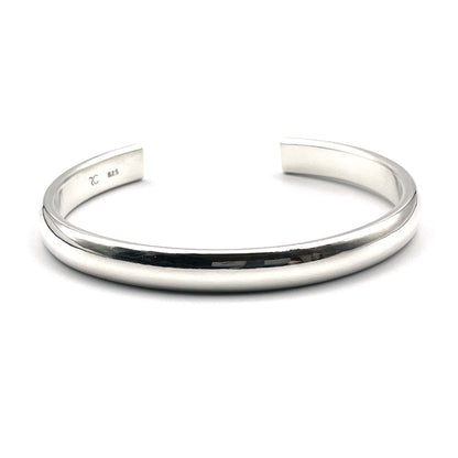 Heavy half-round sterling silver cuff bracelet on a white background.