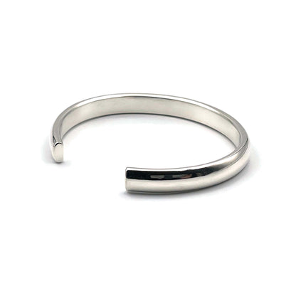 Heavy half-round sterling silver cuff bracelet on a white background.