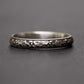 Sterling silver flower ring for women on a dark grey background