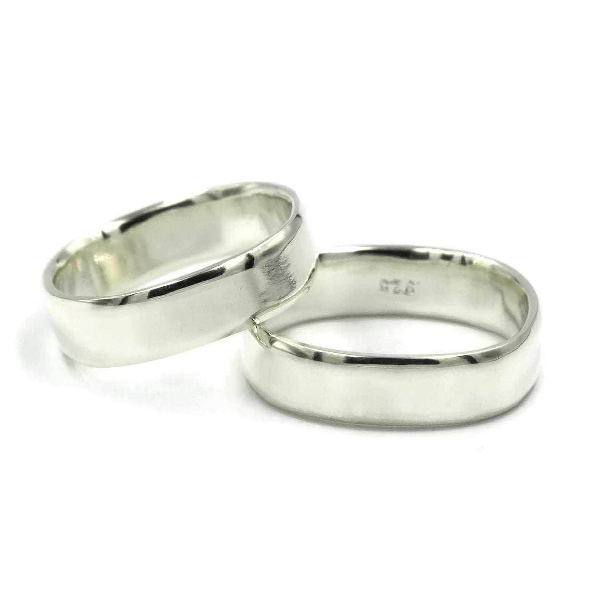 Pair of square sterling silver wedding rings with bevelled edges, handmade in Australia, laying flat on white background