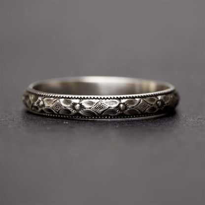 Sterling silver flower ring for women on a dark grey background